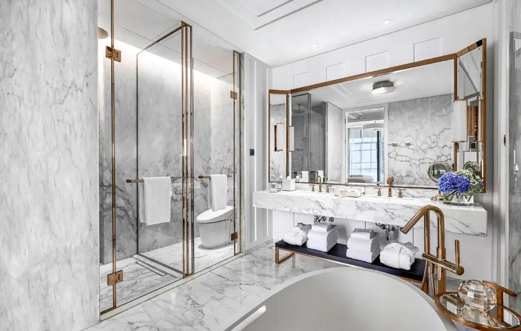 Moderner Duschbereich aus Glas und Marmor in einem eleganten Badezimmer
