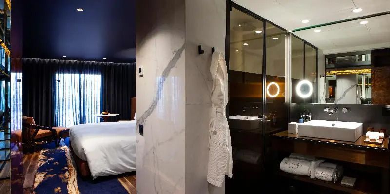 Luxuriöses Bad mit modernem Design neben einem einladenden Doppelzimmer im Forte de Gaia Hotel.