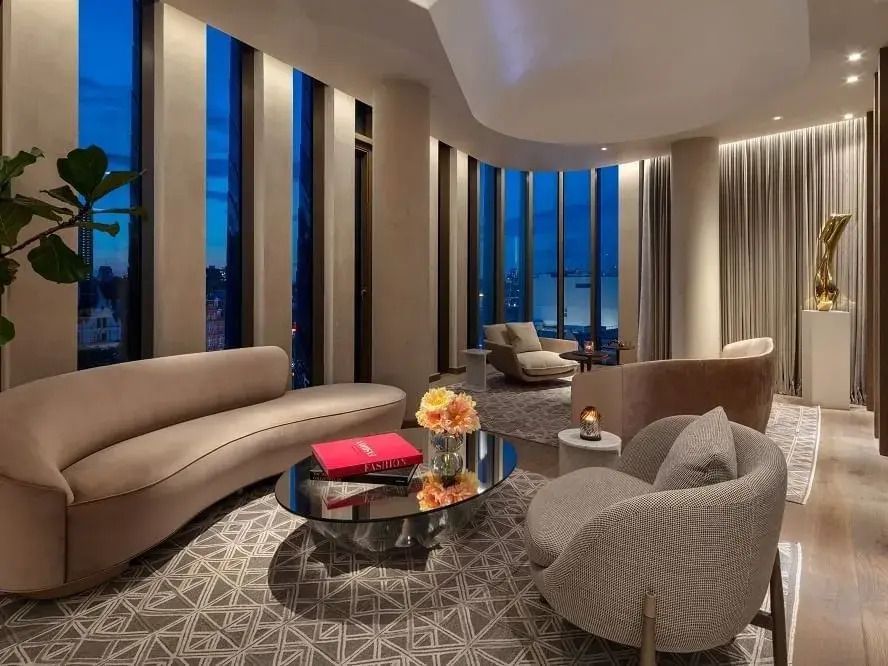 Wohnbereich der Tower Penthouse Suite mit Panoramafenstern und moderner Einrichtung
