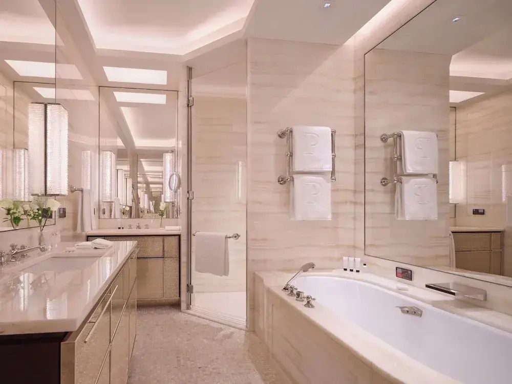 Modernes Badezimmer mit großer Badewanne und Handtüchern.