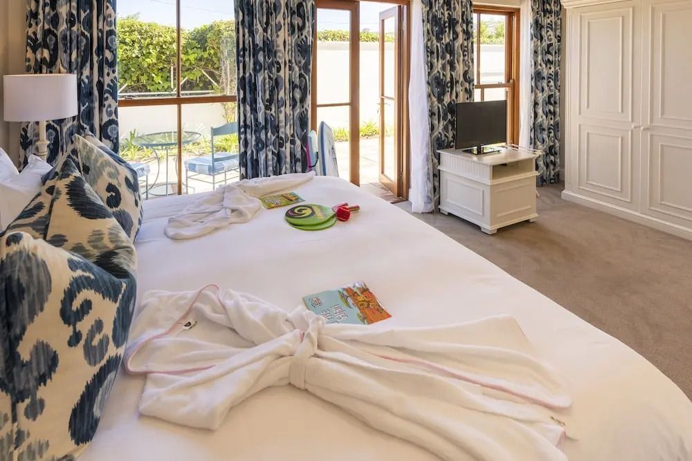 Luxus Zimmer mit Doppelbett, großen Fenstern und gemütlicher Sitzecke