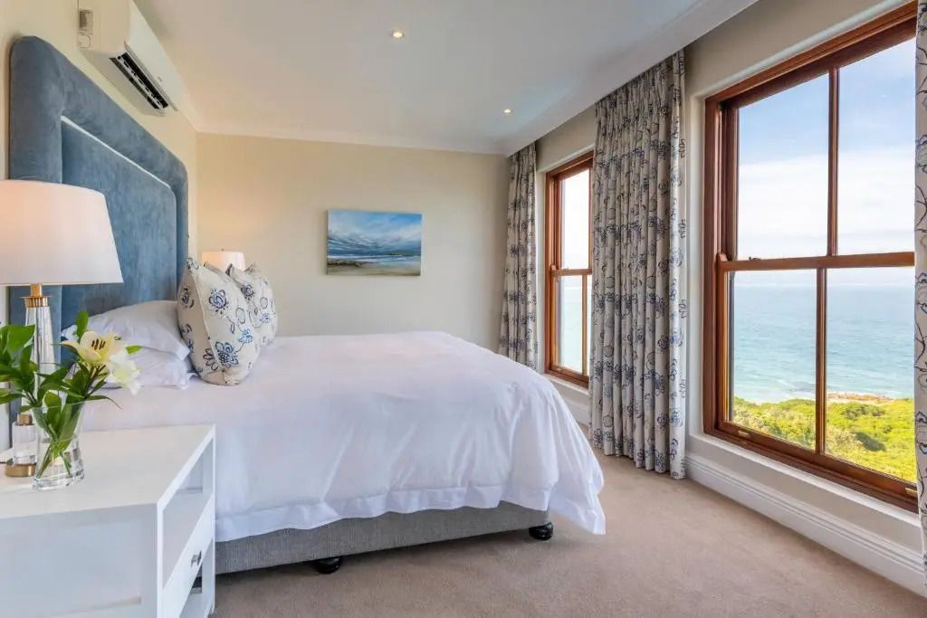Geräumiges Schlafzimmer in der Premier Suite mit Meerblick und eleganter Einrichtung