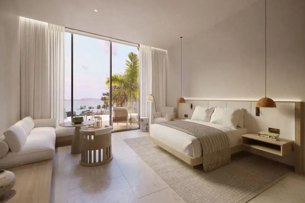 Helles Zimmer mit Doppelbett und eingeschränktem Meerblick durch große Fenster