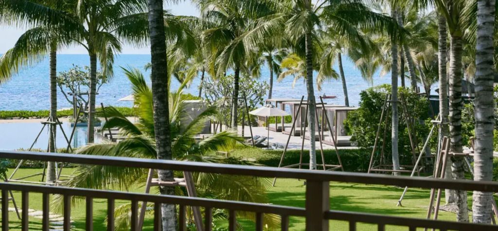 Blick vom Balkon auf Garten und Meer mit Palmen bei The Retreat Koh Chang