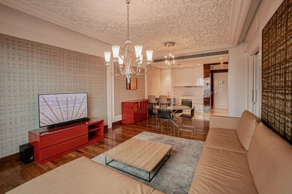 Geräumiges Wohnzimmer mit eleganter Einrichtung und stilvollem Leuchter.