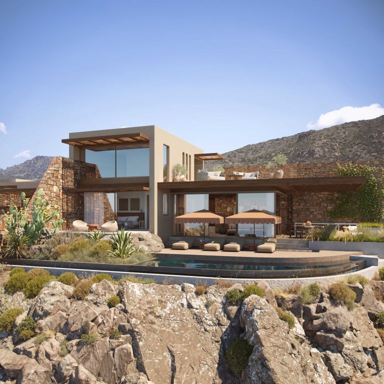 Villa mit moderner Architektur umgeben von Felsen mit privater Terrasse und Liegen