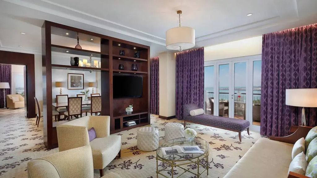 Elegantes Wohnzimmer der Royal Klub Suite mit luxuriösem Mobiliar und Balkonblick aufs Meer