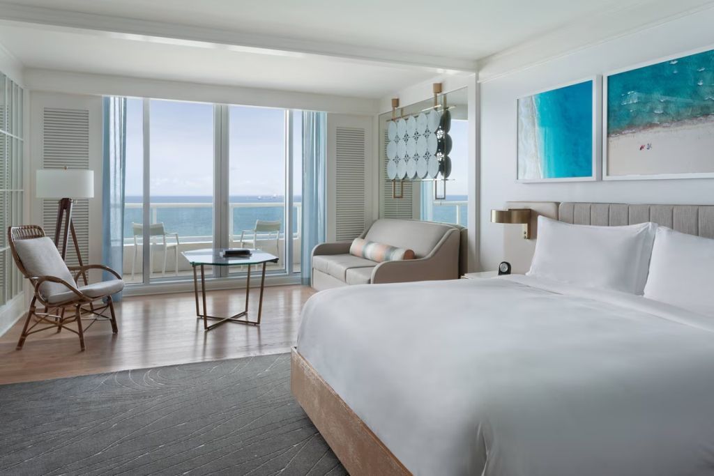 Geräumiges Zimmer mit Doppelbett und Lounge-Bereich sowie Meerblick