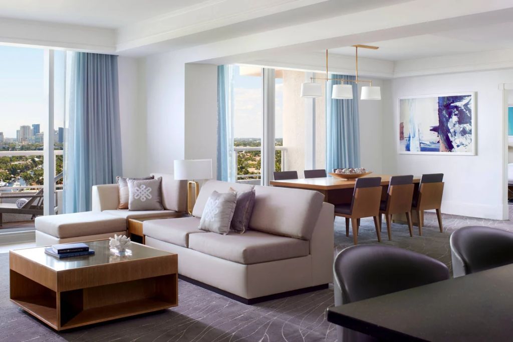 Elegantes Wohnzimmer der Residential Intracoastal Suite mit großem Fenster und Esstisch