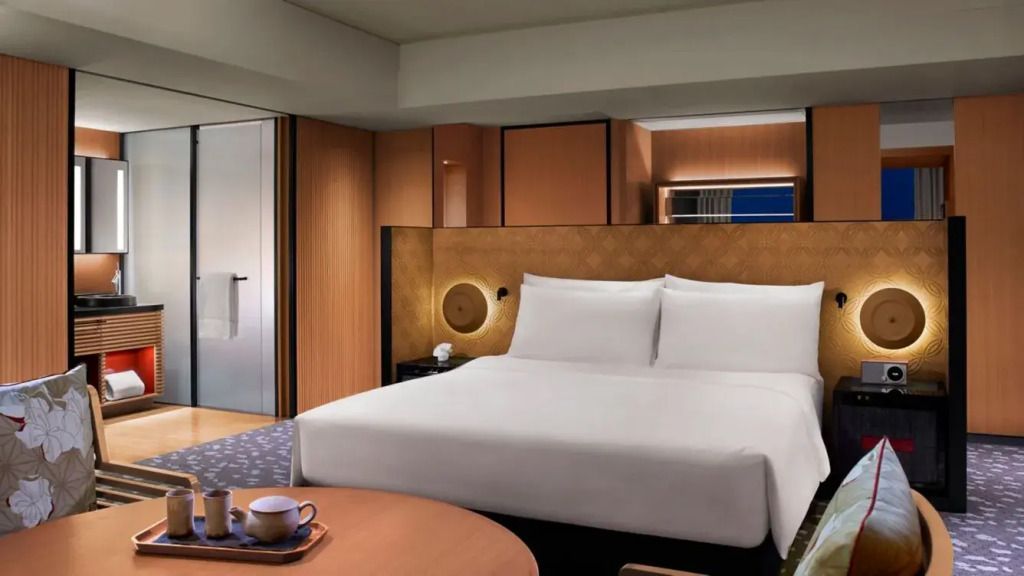Gemütliches Doppelzimmer mit Sitzbereich und stilvollen Holzelementen.