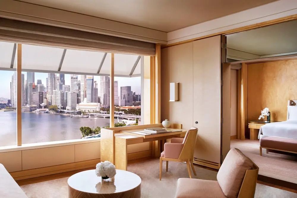 Helles Zimmer mit Arbeitsbereich und Blick auf die Skyline von Singapur.