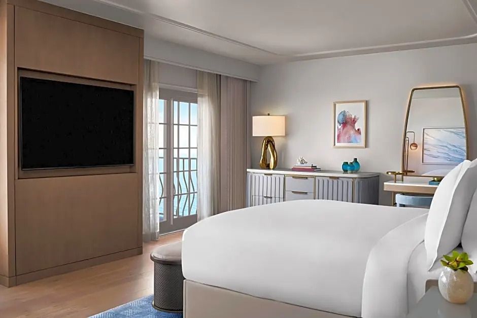 Elegantes Schlafzimmer mit Doppelbett und Balkonblick im The Ritz-Carlton Naples.