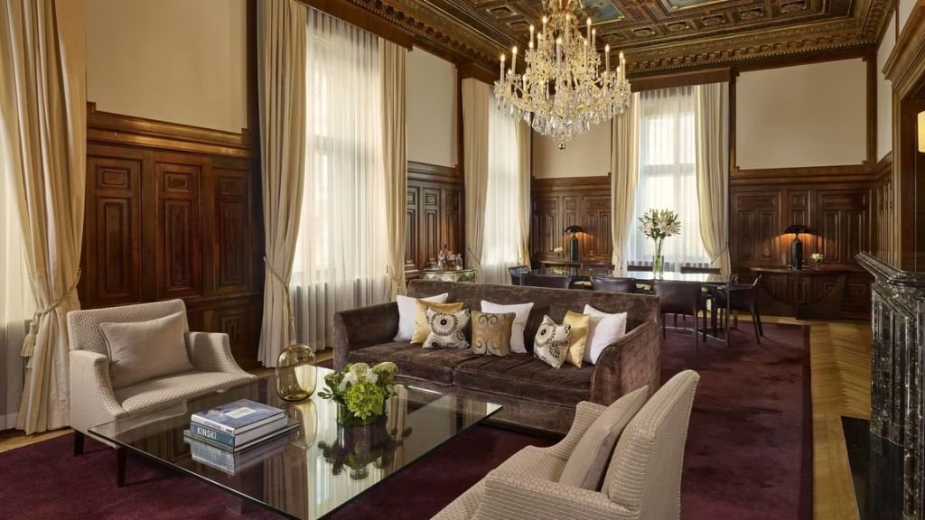 Luxuriöses Wohnzimmer mit prächtigem Kronleuchter und opulenten Vorhängen