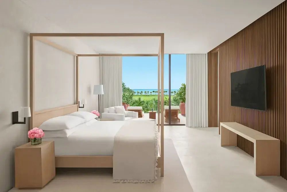 Geräumige Suite mit Himmelbett und Meerblick vom Balkon im Hintergrund