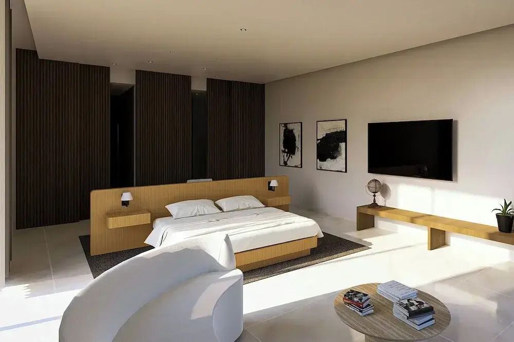 Geräumiges Schlafzimmer mit Doppelbett, Flachbild-TV und moderner Einrichtung
