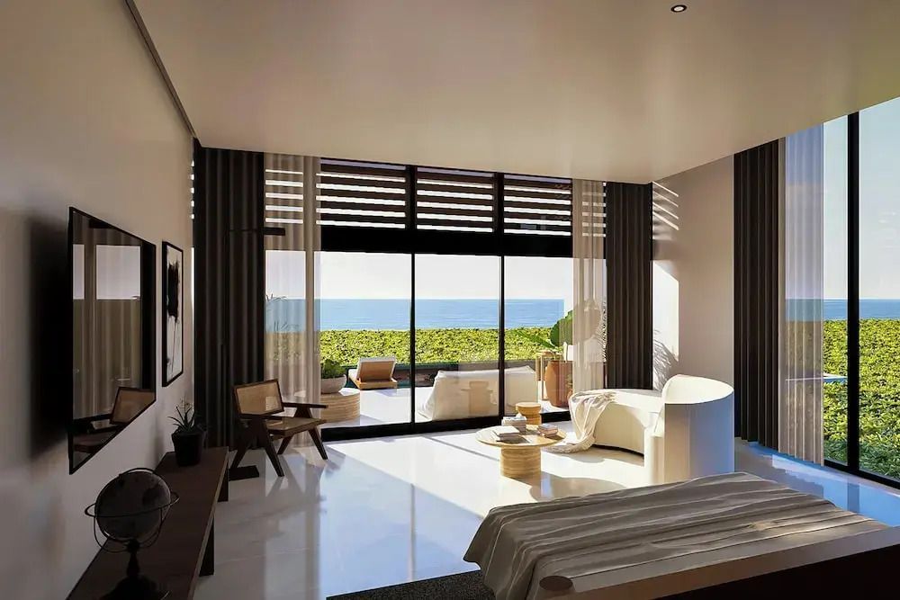 Modernes Schlafzimmer mit Meerblick und Sitzbereich auf dem Balkon