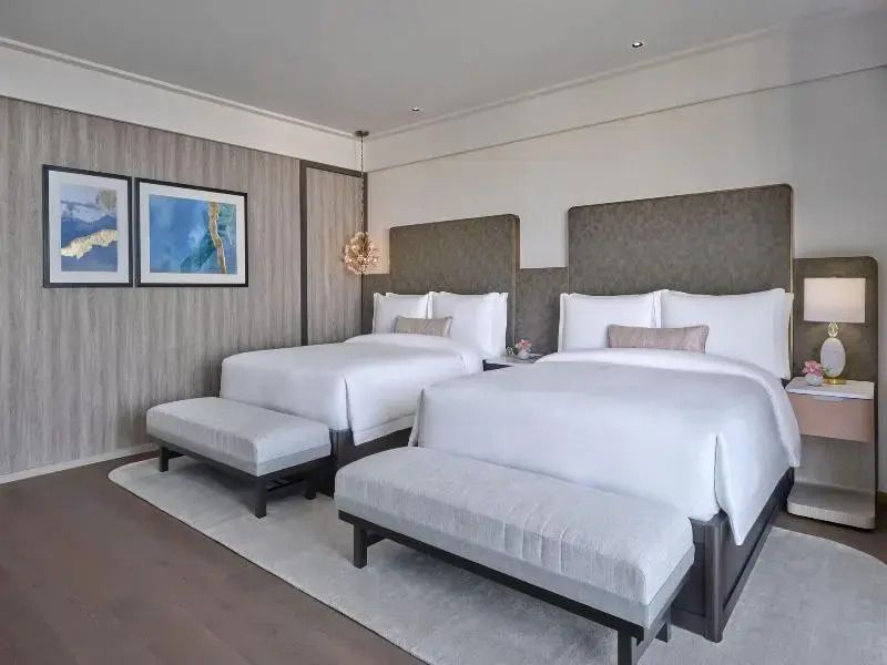 Modernes Hotelzimmer mit zwei Doppelbetten und stilvoller Einrichtung
