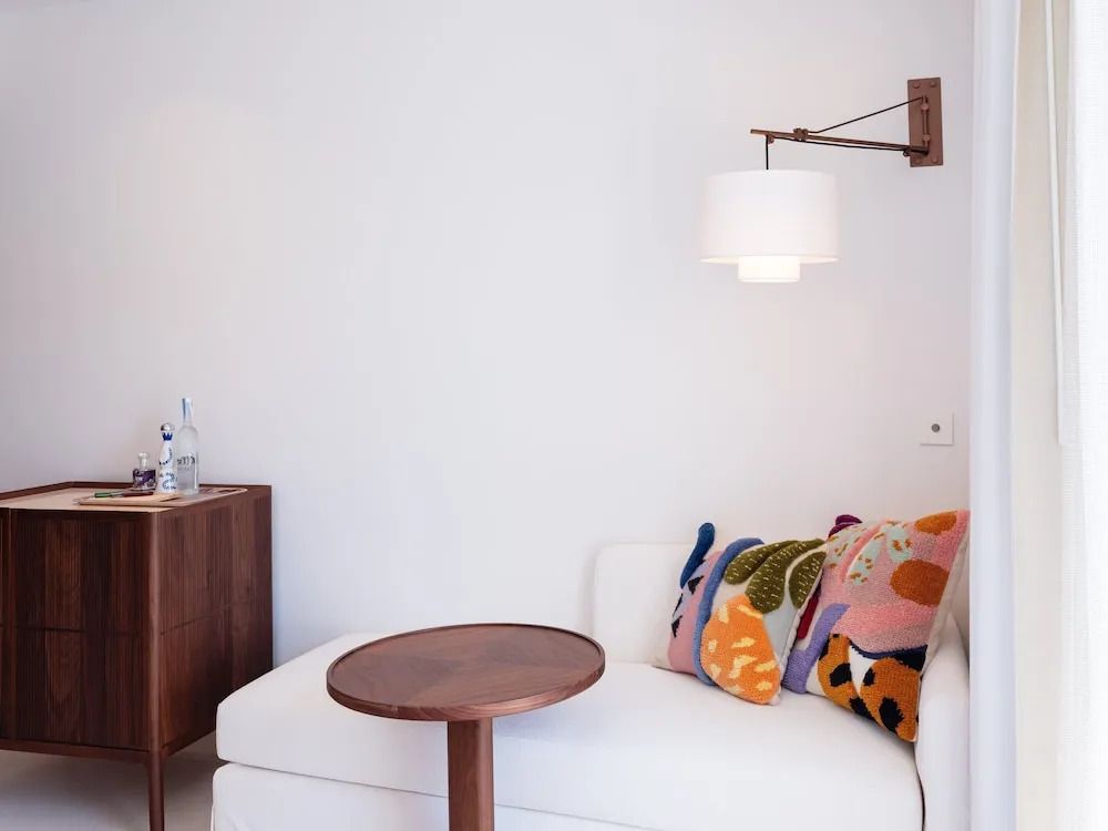 Gemütliche Sitzecke mit farbenfrohen Kissen und kleinem Tisch.
