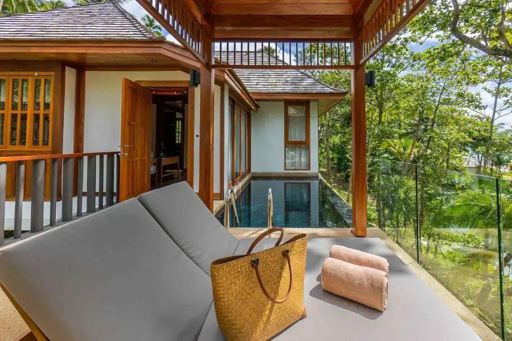 Private Terrasse mit Pool und Relaxliegen umgeben von tropischer Natur