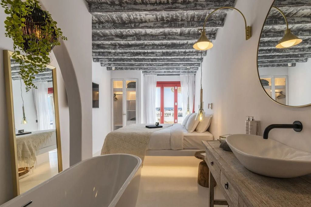 Moderne Suite mit freistehender Badewanne und rustikalen Details