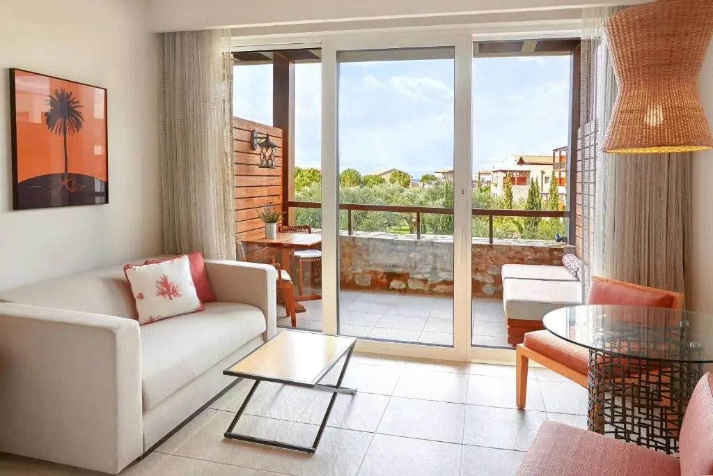 Moderner Wohnbereich mit direktem Zugang zum Balkon im The Romanos Costa Navarino