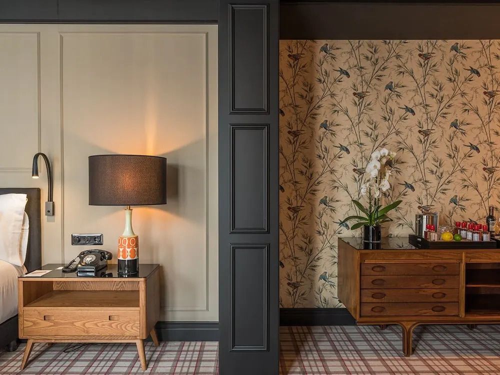 Zimmerdetail mit stilvollem Sideboard und floraler Tapete