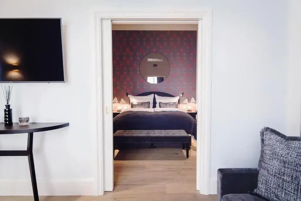 Elegantes Hotelzimmer mit Bett und dekorativer Tapete