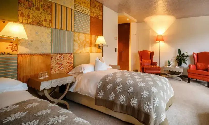 Gemütliches Deluxe Doppelzimmer mit zwei Betten und eleganter Wanddekoration
