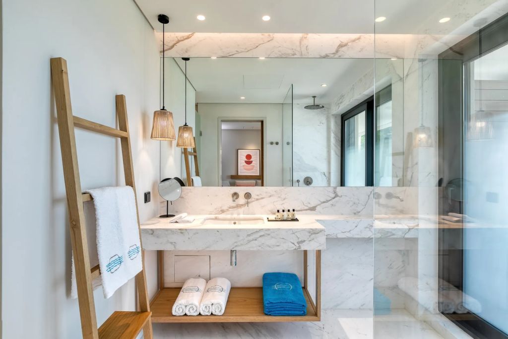 Luxuriöses Badezimmer mit Marmorakzenten und großer Glasdusche