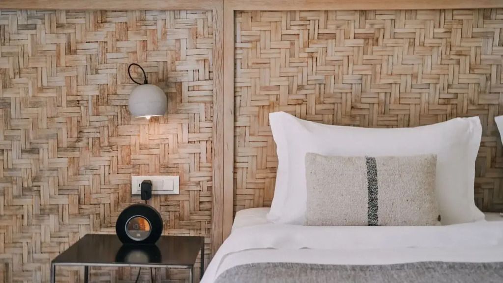 Nahaufnahme eines elegant gestalteten Bettes mit Holzdetails.