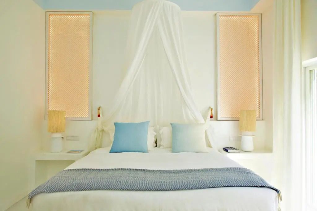 Elegantes Schlafzimmer mit Baldachin und blauen Akzenten in der Superior Suite