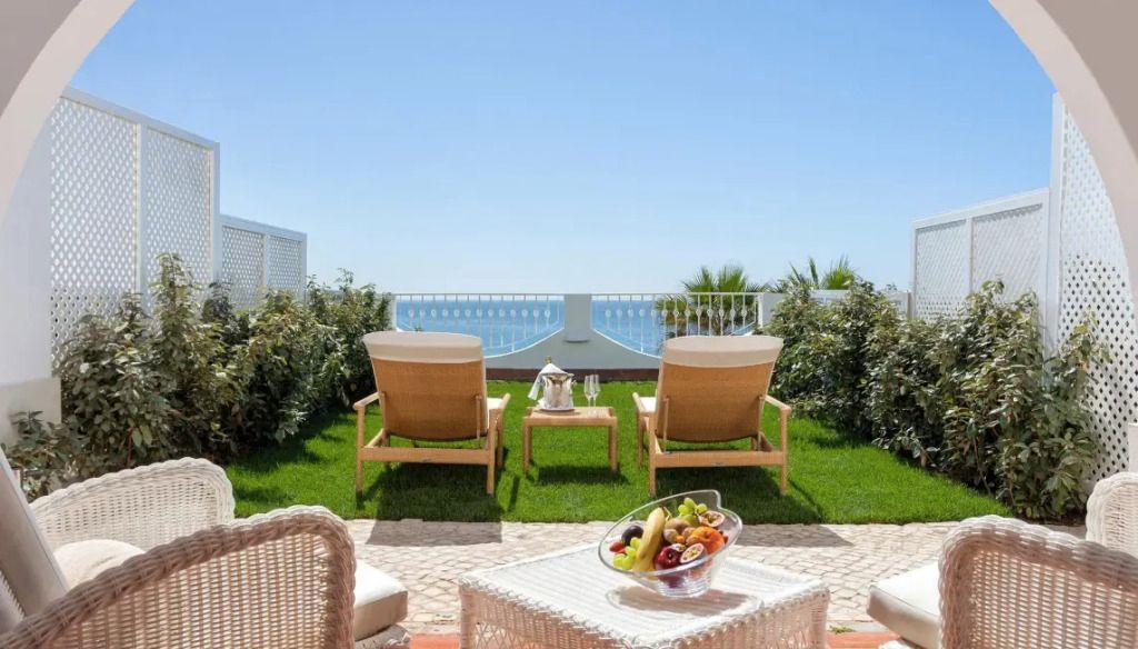 Private Gartenterrasse mit Meerblick und komfortablen Liegestühlen