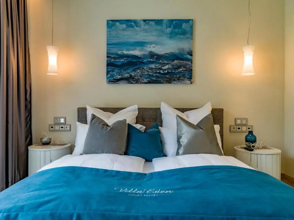 Elegantes Schlafzimmer im Hotel Eden Reserve mit stilvollem Kunstwerk und luxuriöser Bettwäsche