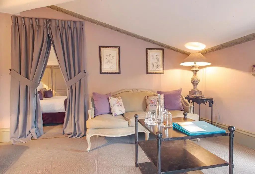 Gemütliche Sitzecke im Zimmer mit antiker Couch und stilvollen Accessoires