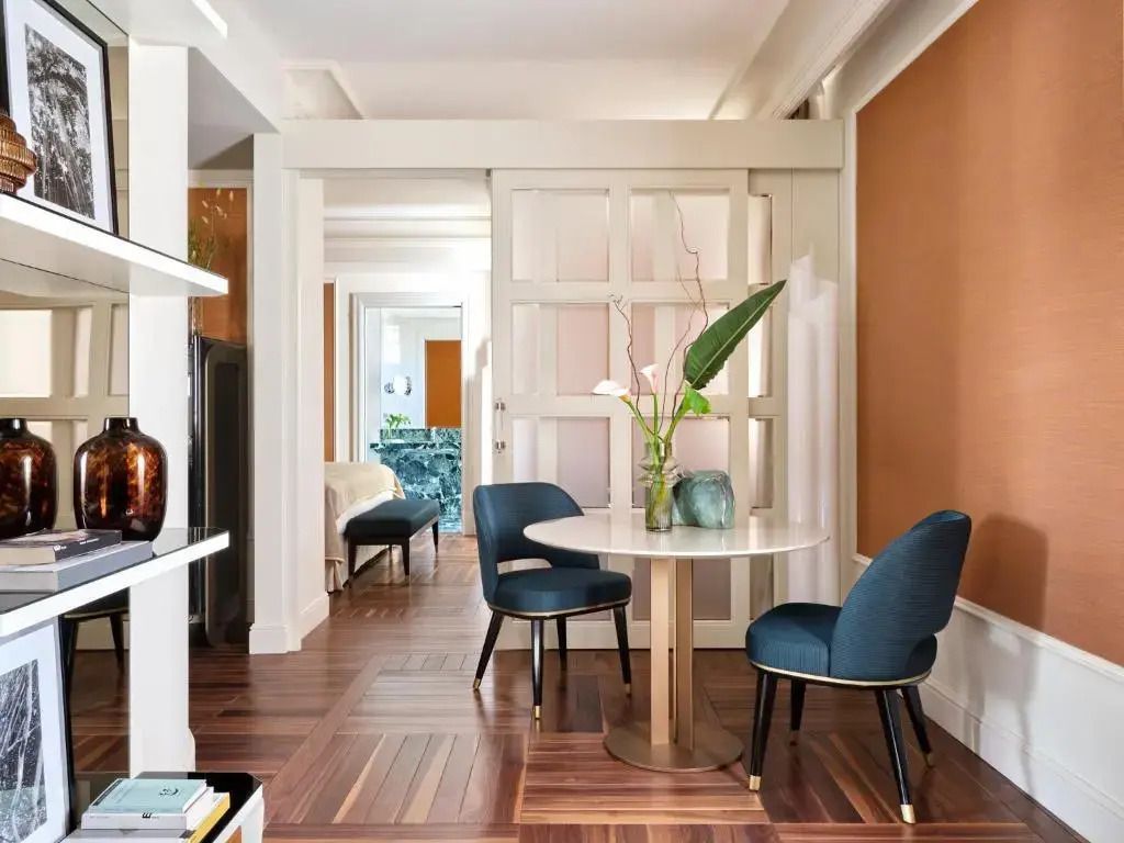 Sitzecke mit rundem Tisch und zwei blauen Stühlen im modernen Stil