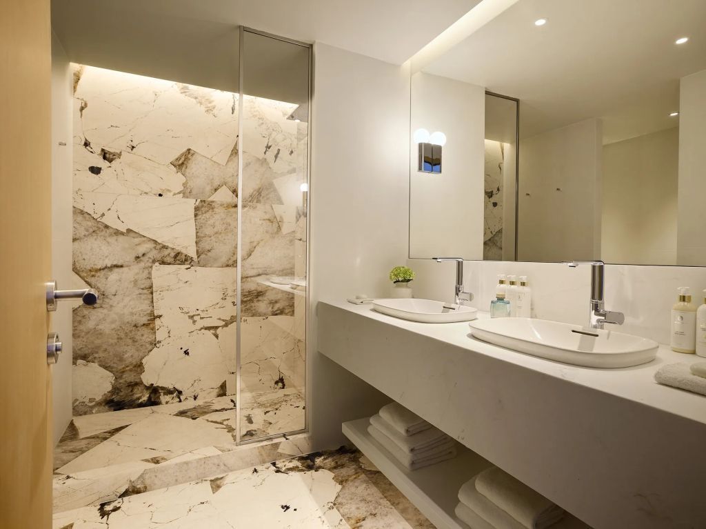 Modernes Badezimmer mit Marmorverkleidung und großer Dusche