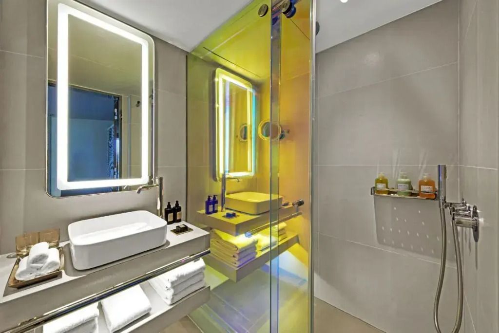 Modernes Badezimmer mit gelb beleuchteter Duschkabine