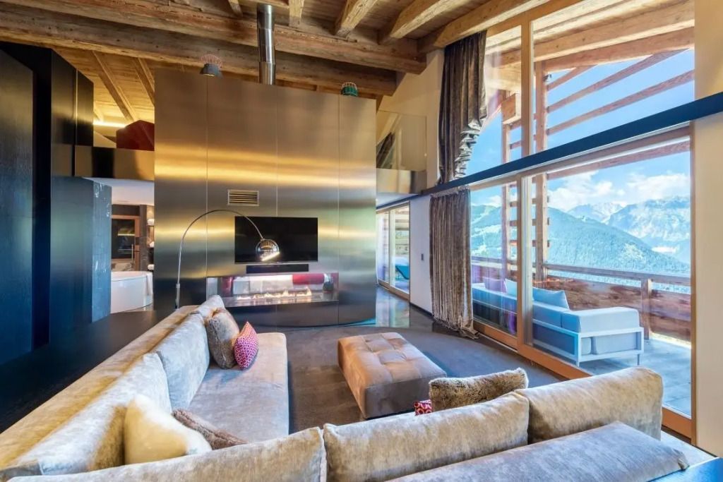 Moderne Suite mit großem Sofa und Blick auf die Alpen.