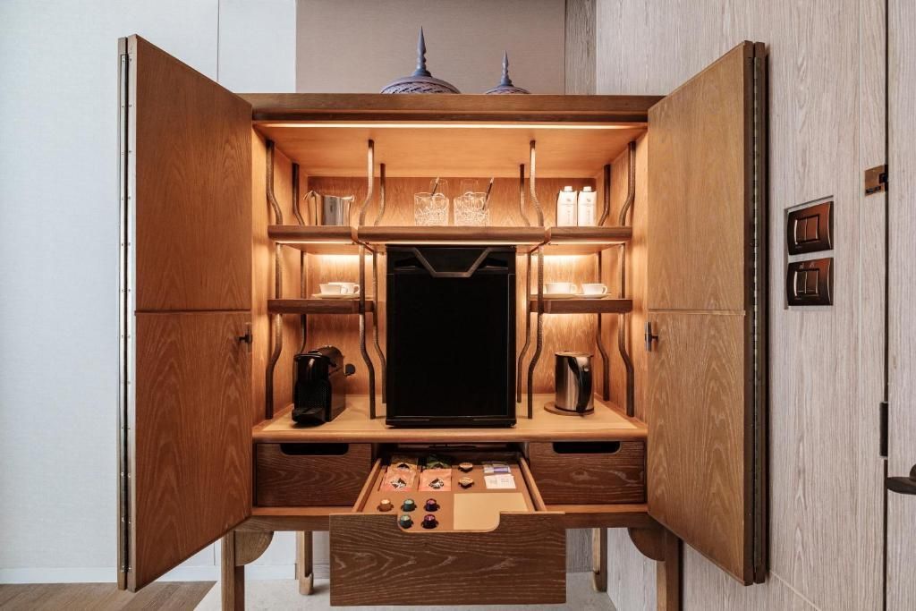 Gut ausgestattete Minibar mit hochwertigen Getränken und Snacks im Schrank