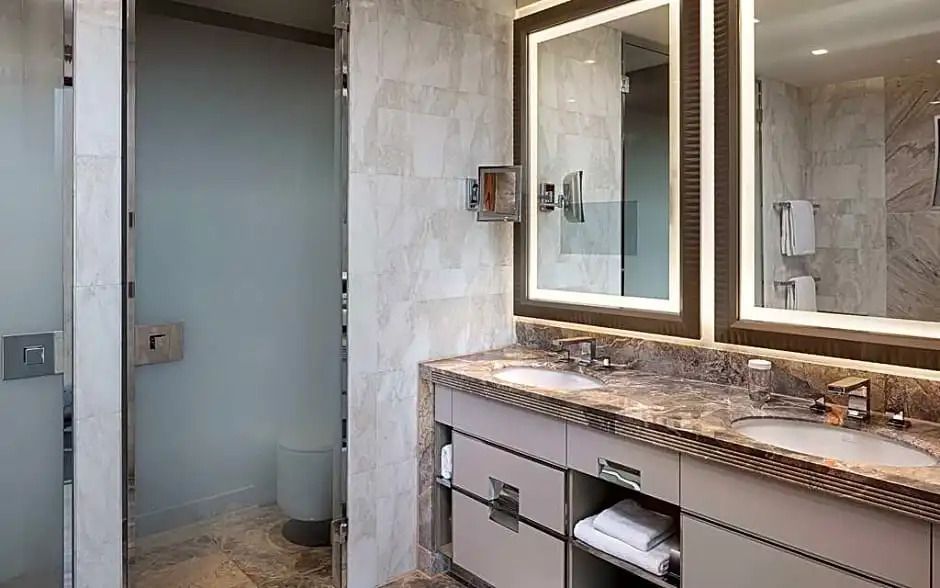 Luxuriöses Badezimmer mit Doppelwaschbecken und großen Spiegeln.