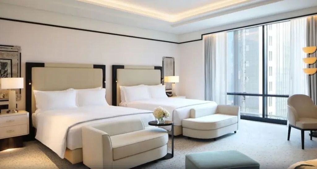 Deluxe Vierer Zimmer mit zwei großen Betten und eleganter Möblierung.