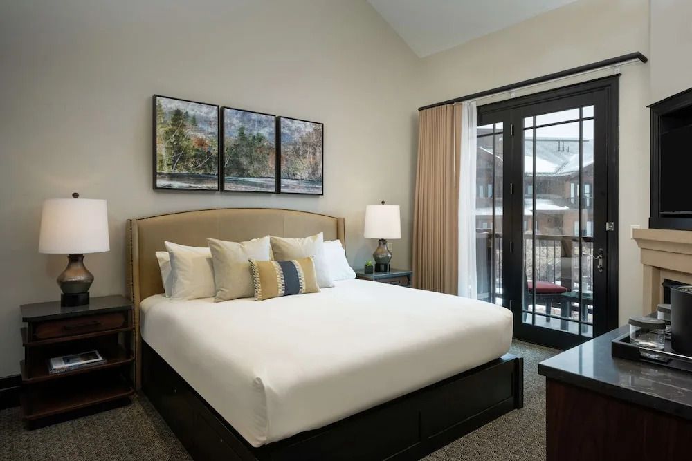 Helles Schlafzimmer mit Kingsize-Bett und Zugang zum Balkon