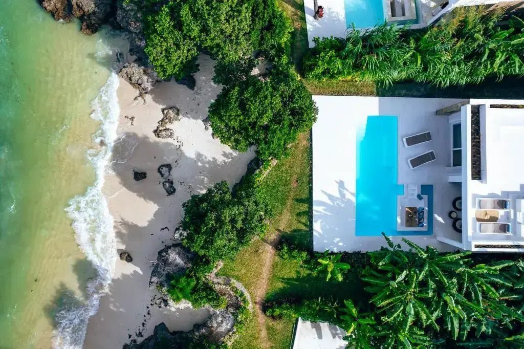 Luftaufnahme der Villa mit privatem Pool und direktem Strandzugang umgeben von tropischer Vegetation