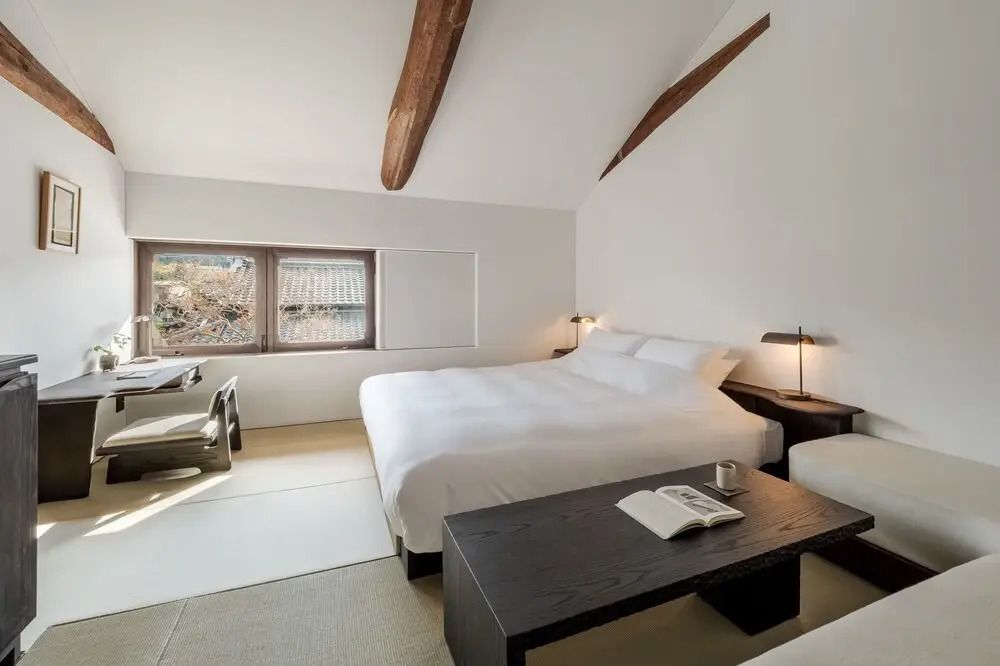 Geräumiges Zimmer mit großem Bett und Schreibtisch im Yoruya Hotel