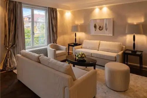 Gemütliches Wohnzimmer mit Sesseln und Sofa in neutralen Tönen