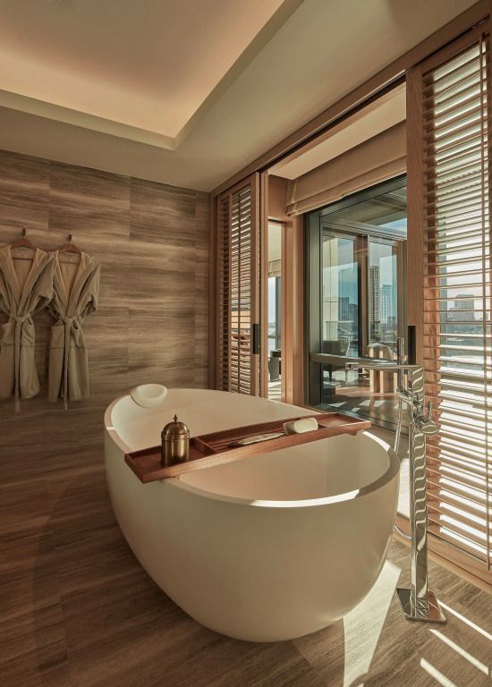 Luxuriöses Badezimmer mit freistehender Badewanne und Fensterblick in Bangkok