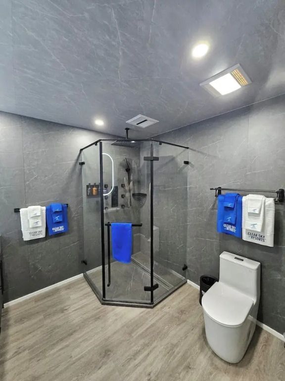 Dusche mit Glaswänden und gepflegtem Fliesenboden in modernem Badezimmer.