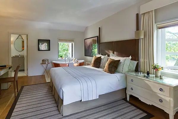 Geräumige Cottage Executive Suite mit einem großen Doppelbett und hellem Dekor.