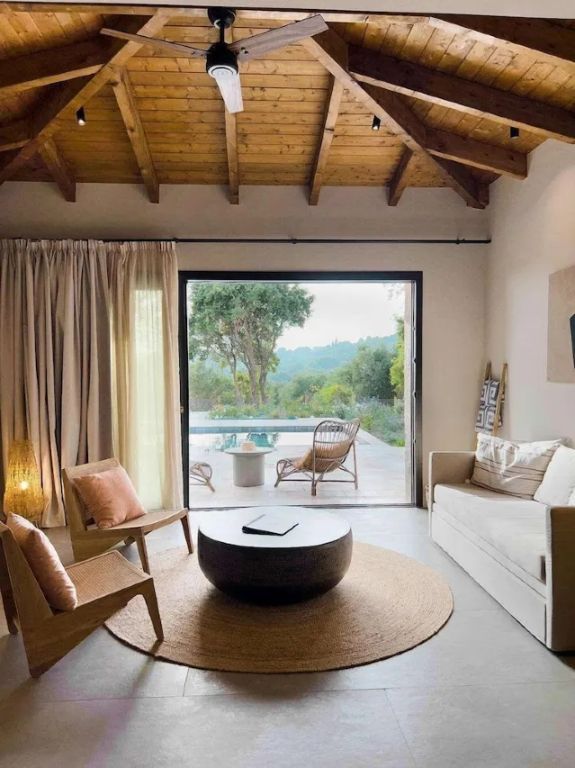 Gemütliches Wohnzimmer mit Blick auf Terrasse und Pool.