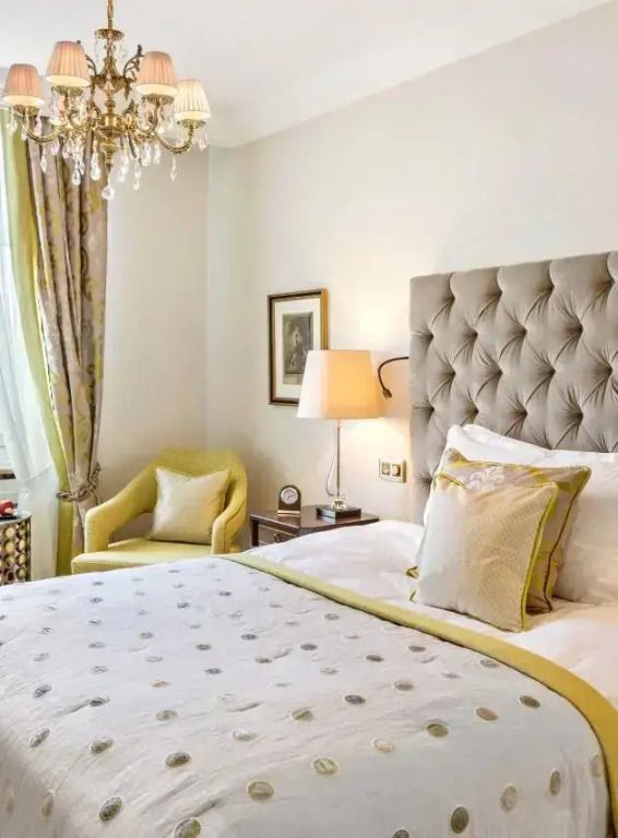 Elegantes Hotelzimmer mit Doppelbett, klassischem Design und Kronleuchter.